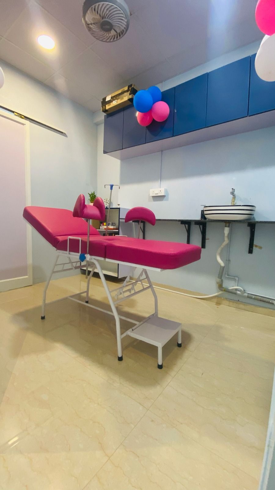 The examination room at Venus Women’s Wellness Clinic with a rose-pink gynaecology couch