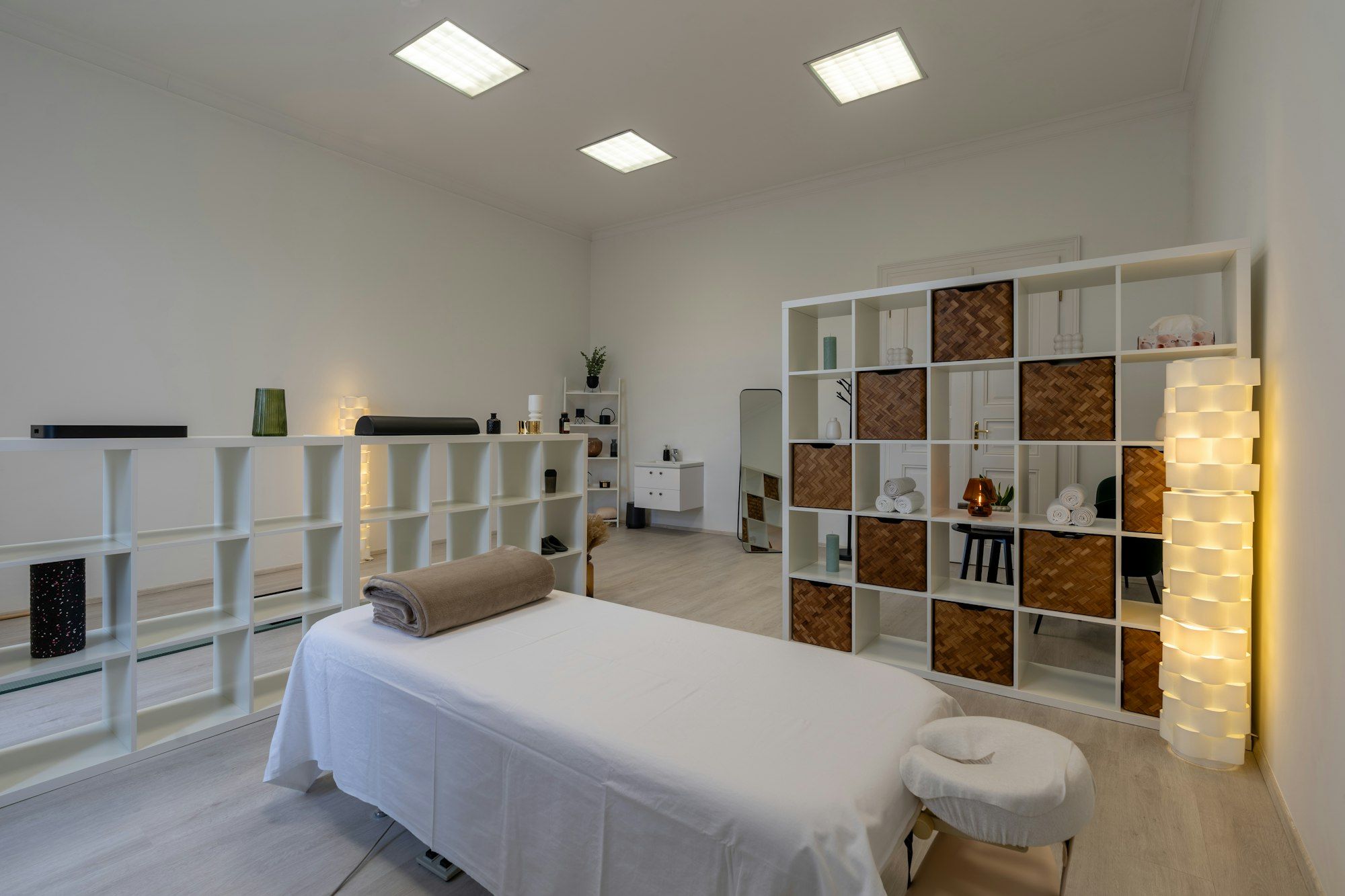 A clean, bright therapy room with a fresh treatment table ready for a session.